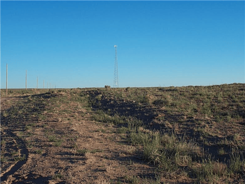 Aerial view of Arizona Navajo County 2.50-acre Rancho Lot 99 and 107 with desert landscape and clear blue sky, natural outdoor scenery.