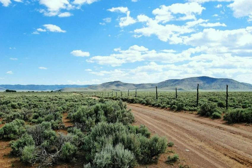 Aerial view of Utah Iron County Garden Valley Ranchos Unit 5 Lot 2584, 1.10 acres of land with open landscape and clear skies.