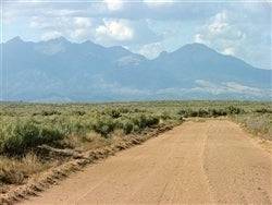 Aerial view of Colorado San Luis Estates South Lot 92 in Costilla County, 5-acre rural land parcel with open terrain and mountain views.